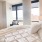 bedroom with large bed and desk with plant on it