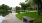 pond area with green grass and spacious sidewalks